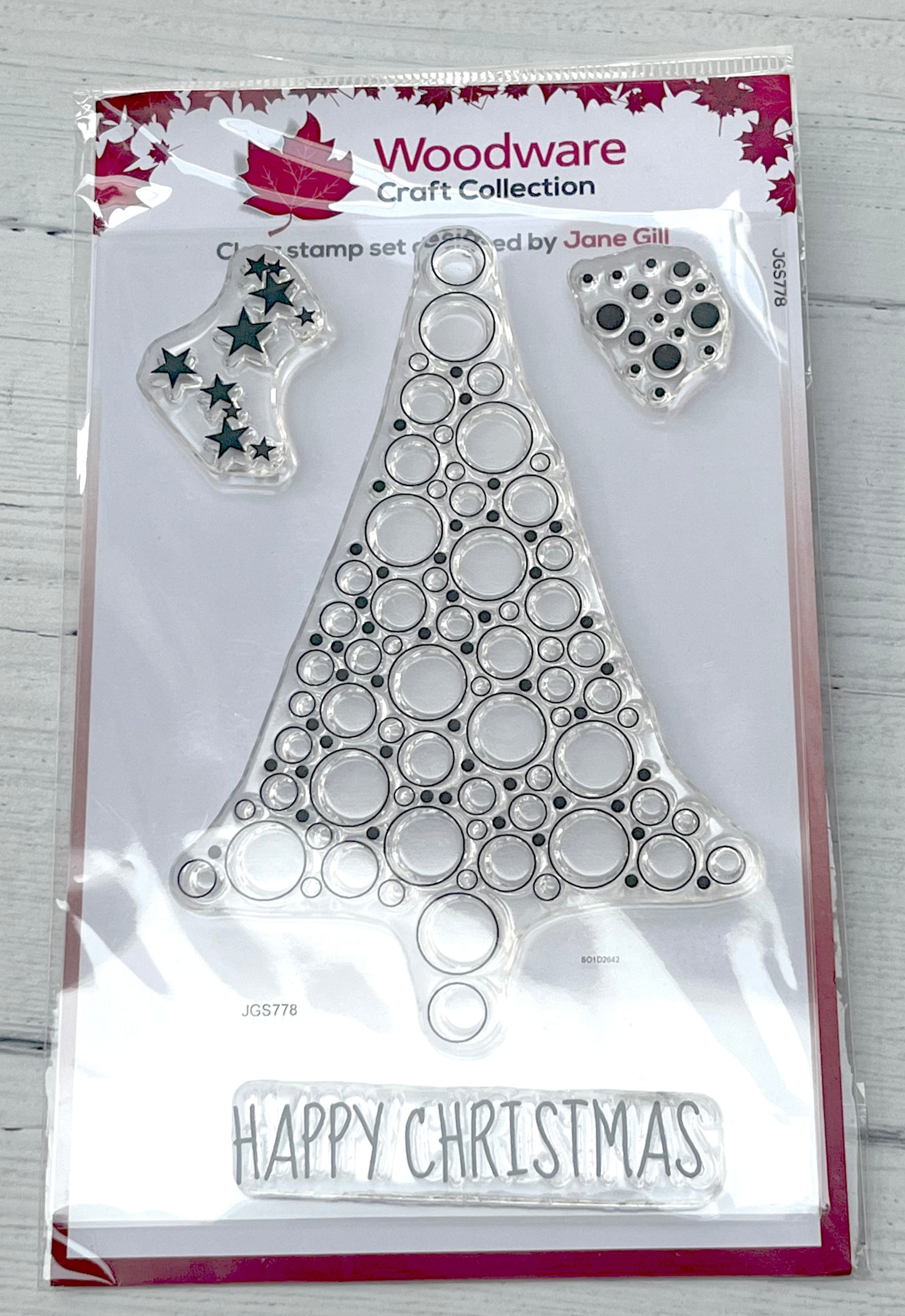 Woodware Craft Collection Christmas tree stamp set packaging on a wooden surface